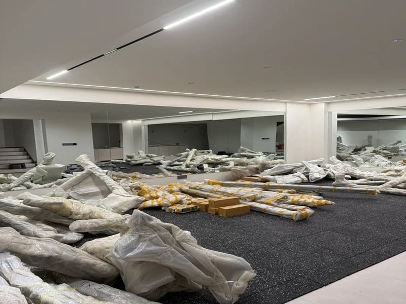 Technician using moisture meter on concrete subfloor